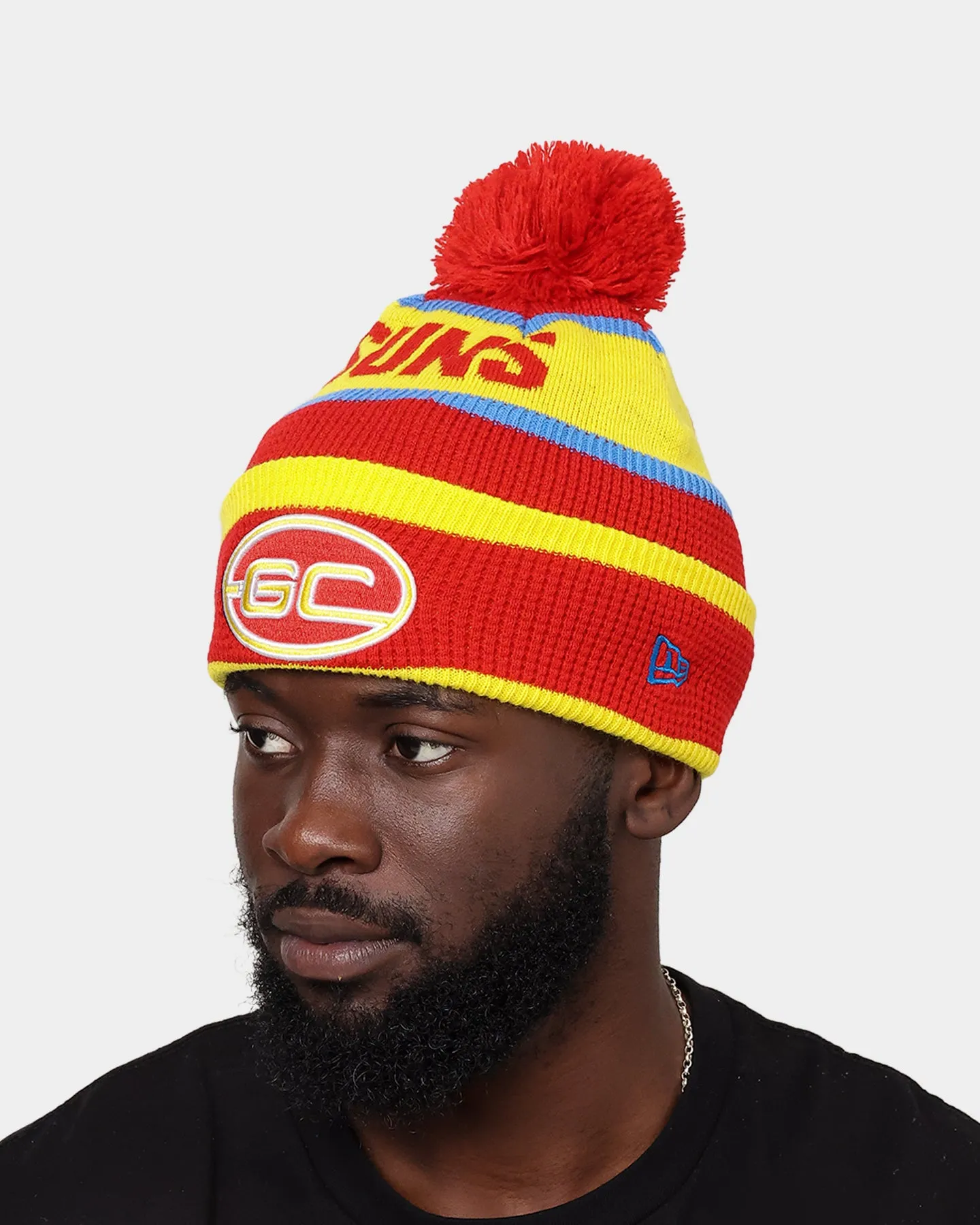 New Era Gold Coast Suns AFL Opening Bounce 2022 Pom Waffle Wordmark Beanie Red/Yellow